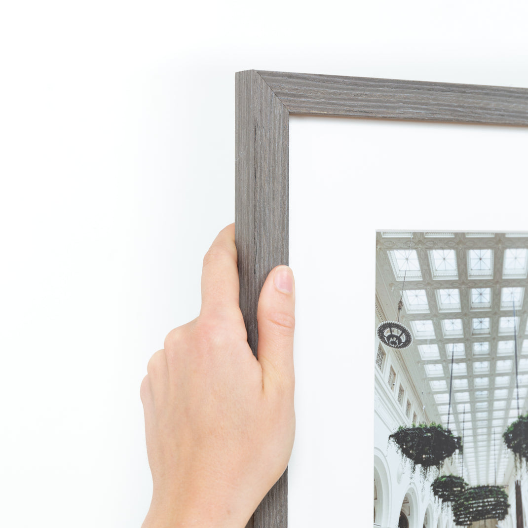 top left corner of architectural photo of a museum ceiling framed in gray Everett frame with a white mat