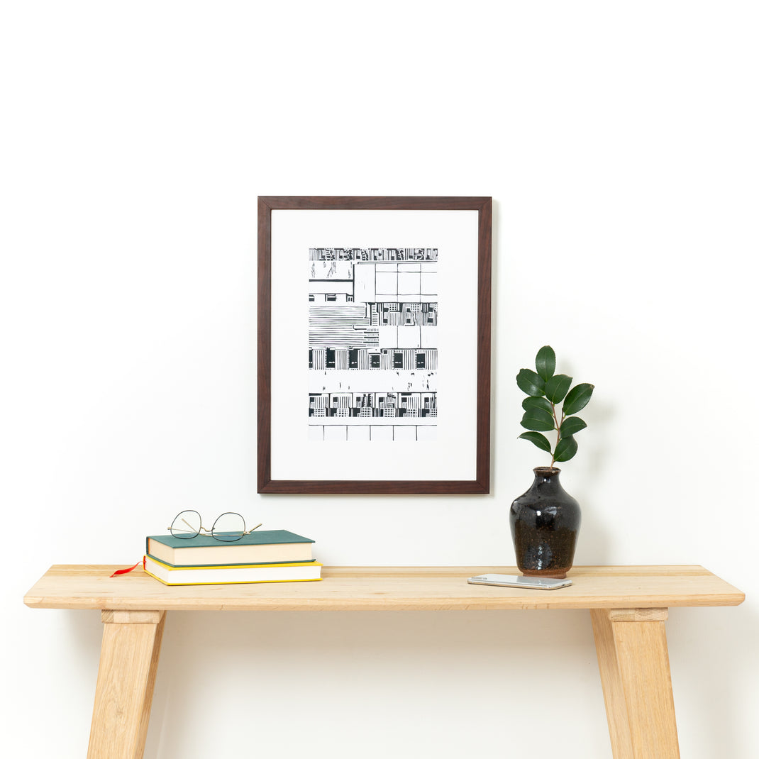Black & White lithograph in Verona framed over a console table