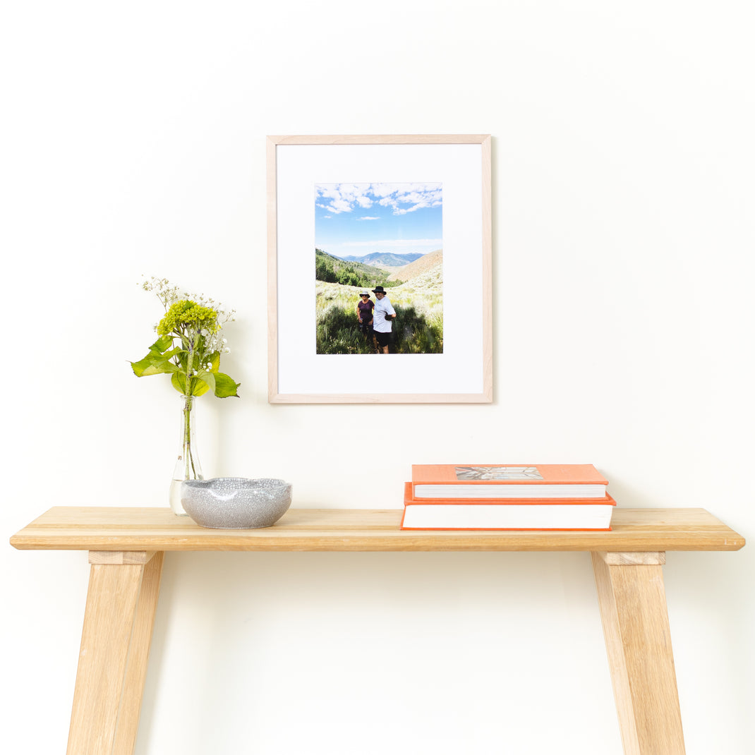 vignette of bleached maple mini with framed photo of a couple in a beautiful vista