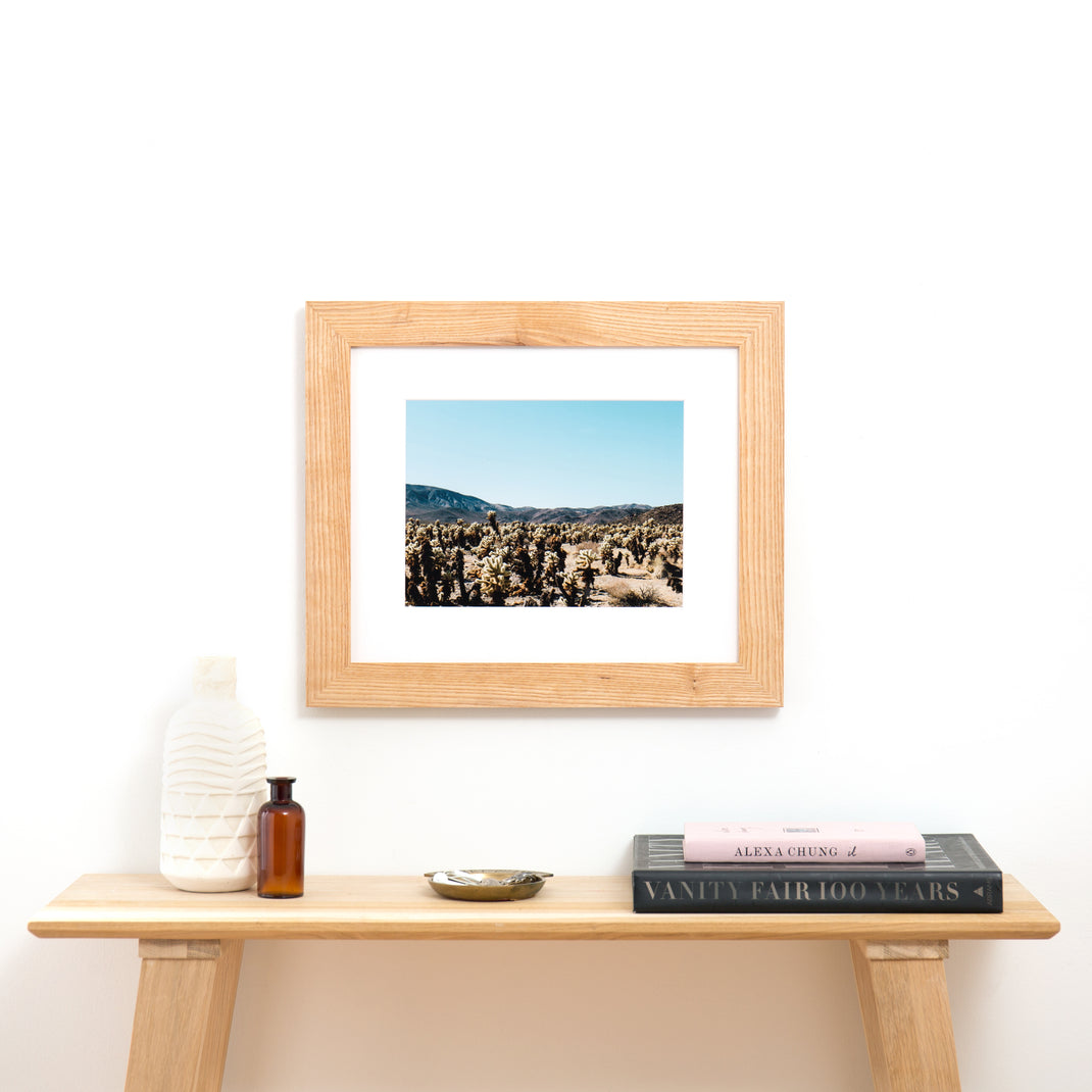 Desert vista framed in Ash Wide frame with a white mat hanging above an entry table