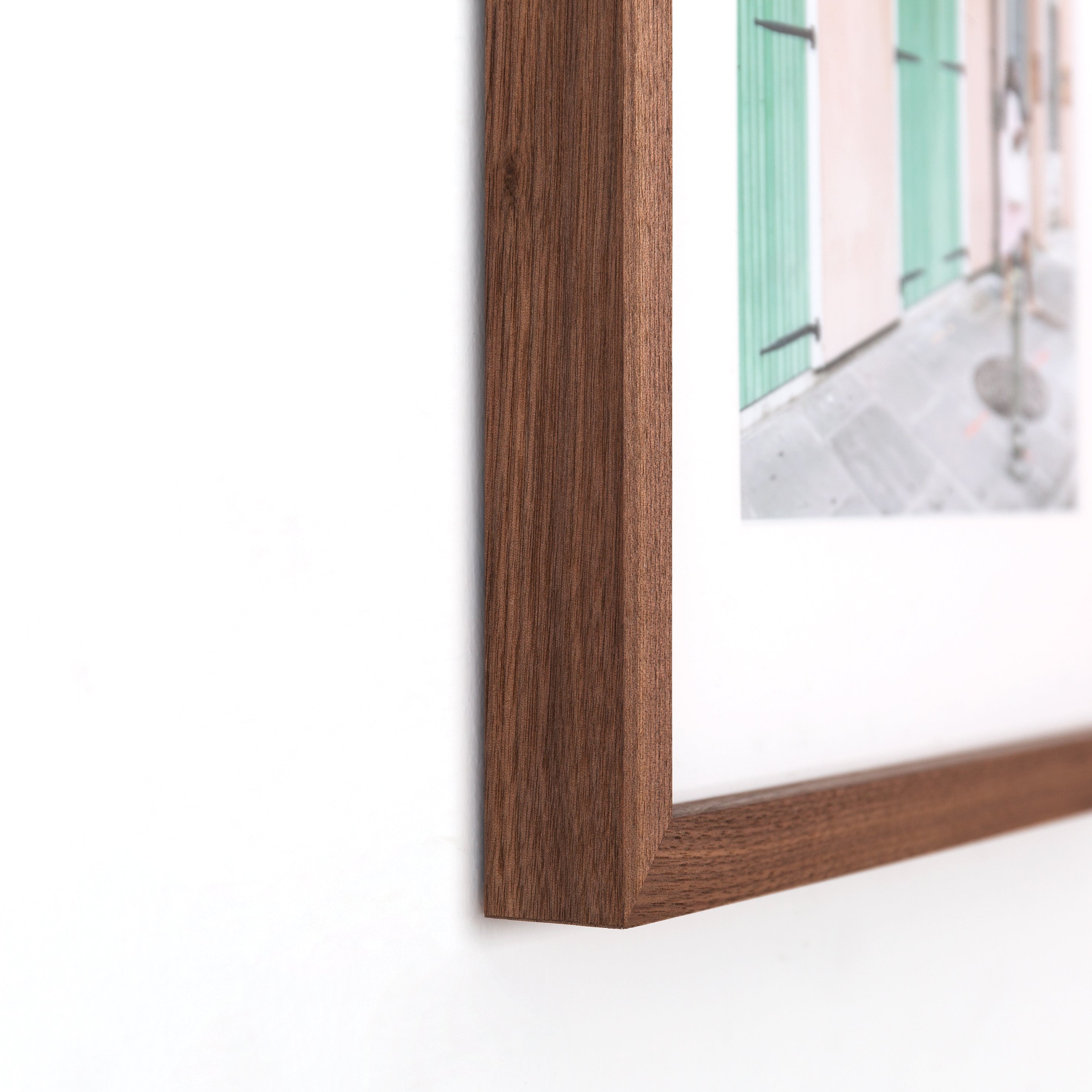 bottom left corner of travel photo of a woman exploring framed in Walnut gallery hardwood frame style with a white mat