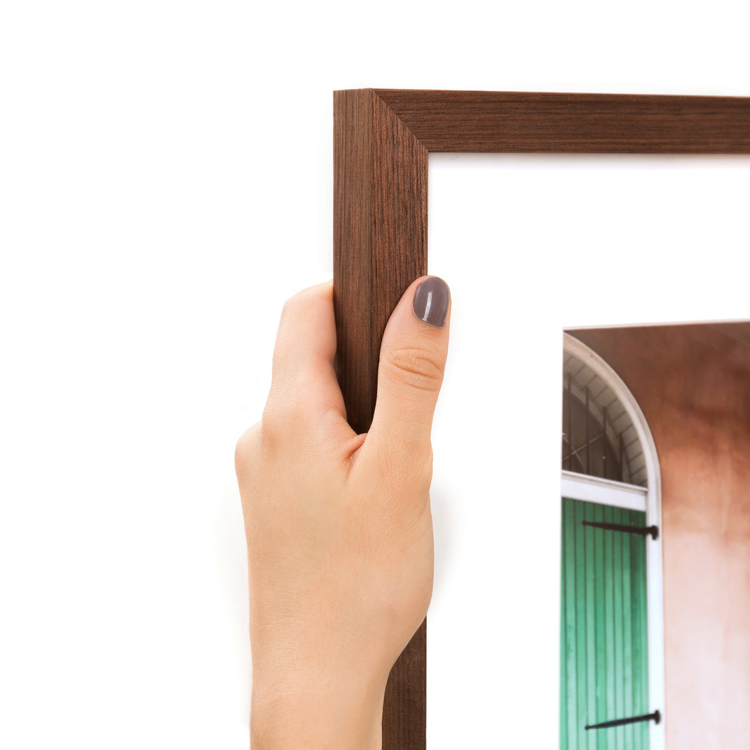 top left corner of travel photo of a woman exploring framed in Walnut gallery hardwood frame style with a white mat