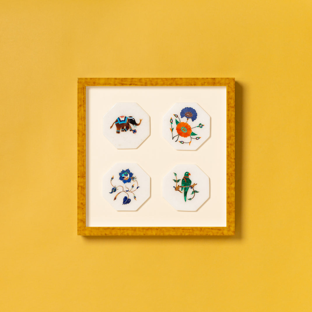 four fabric embroidered coasters framed in mustard yellow glazed Agra frame on a white mat