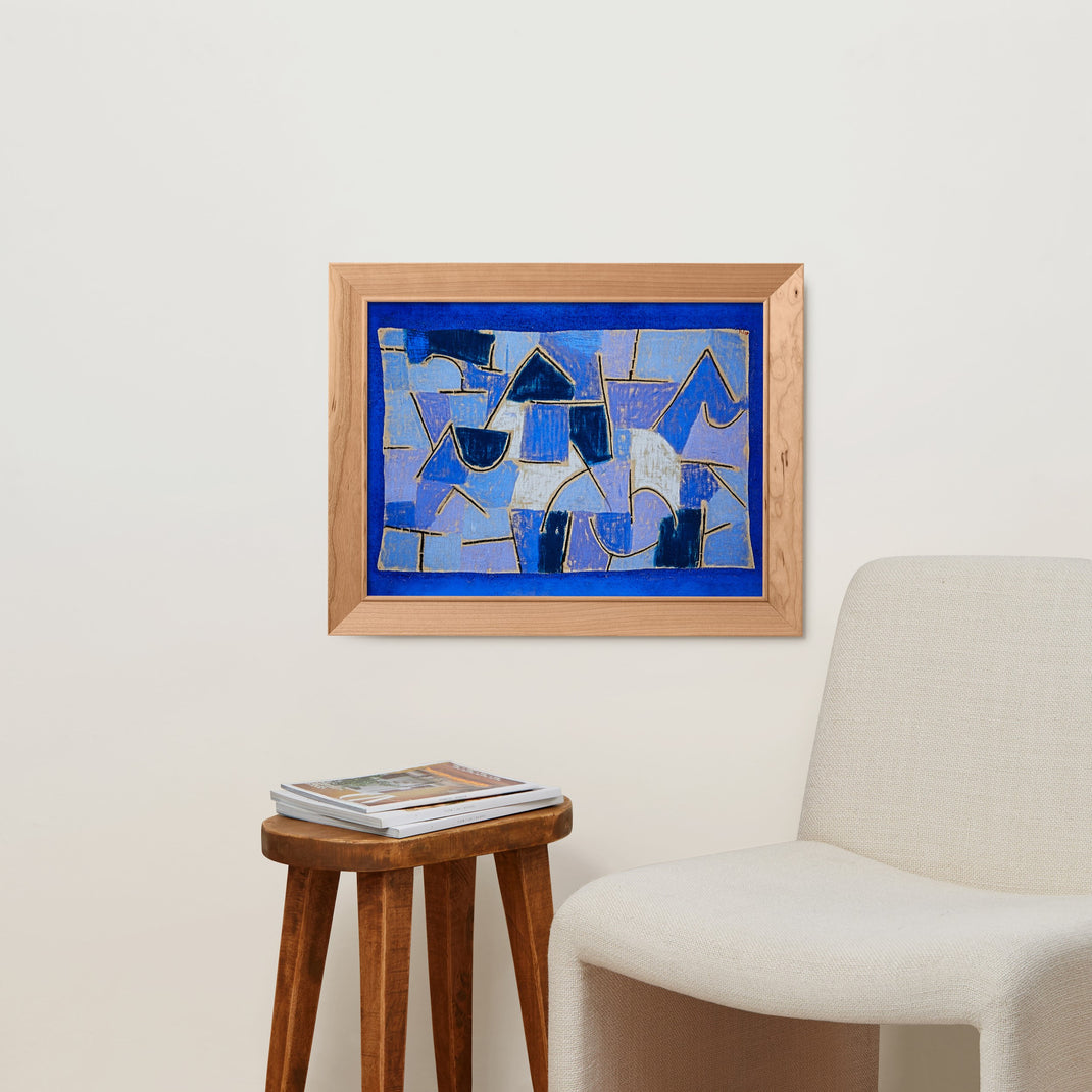 Colorful blue abstract painting in an angled cherry hardwood hanging on a white wall next to walnut table