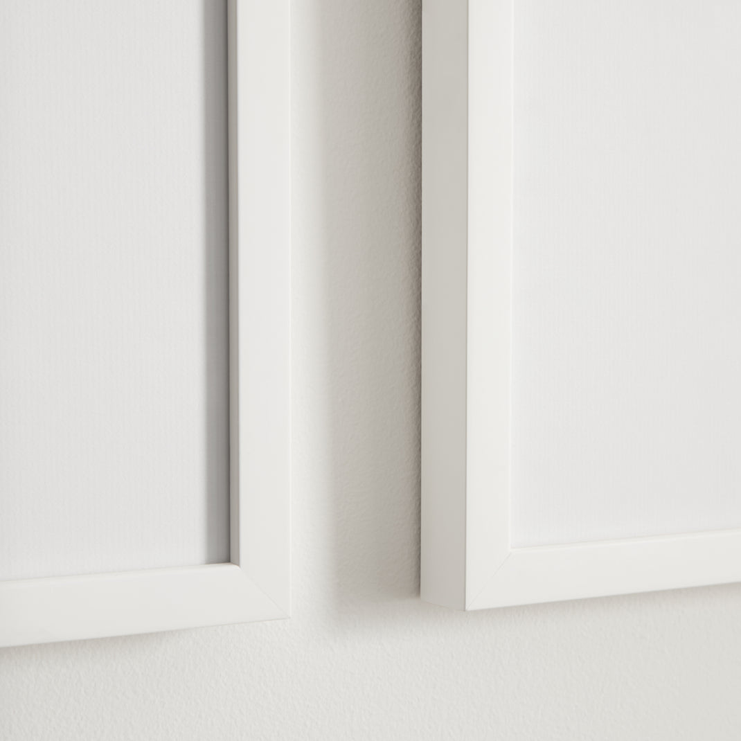 Two white frame with black and white photos