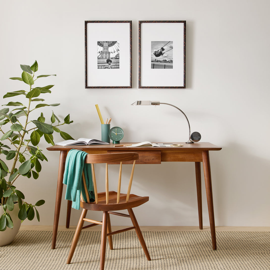 Two tortoiseshell frames with black and white photos