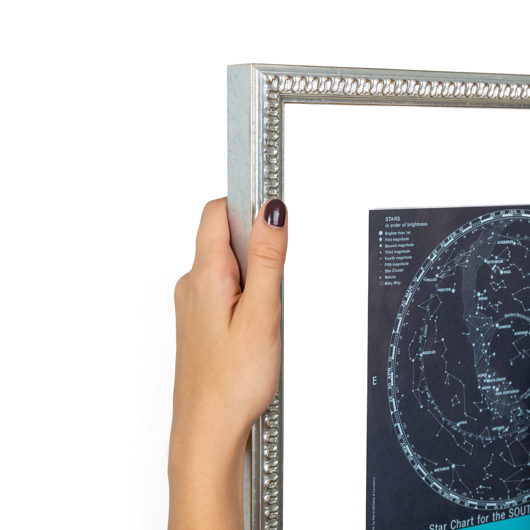 top left corner of star chart of the southern skies framed in Dover silver frame with wave detail