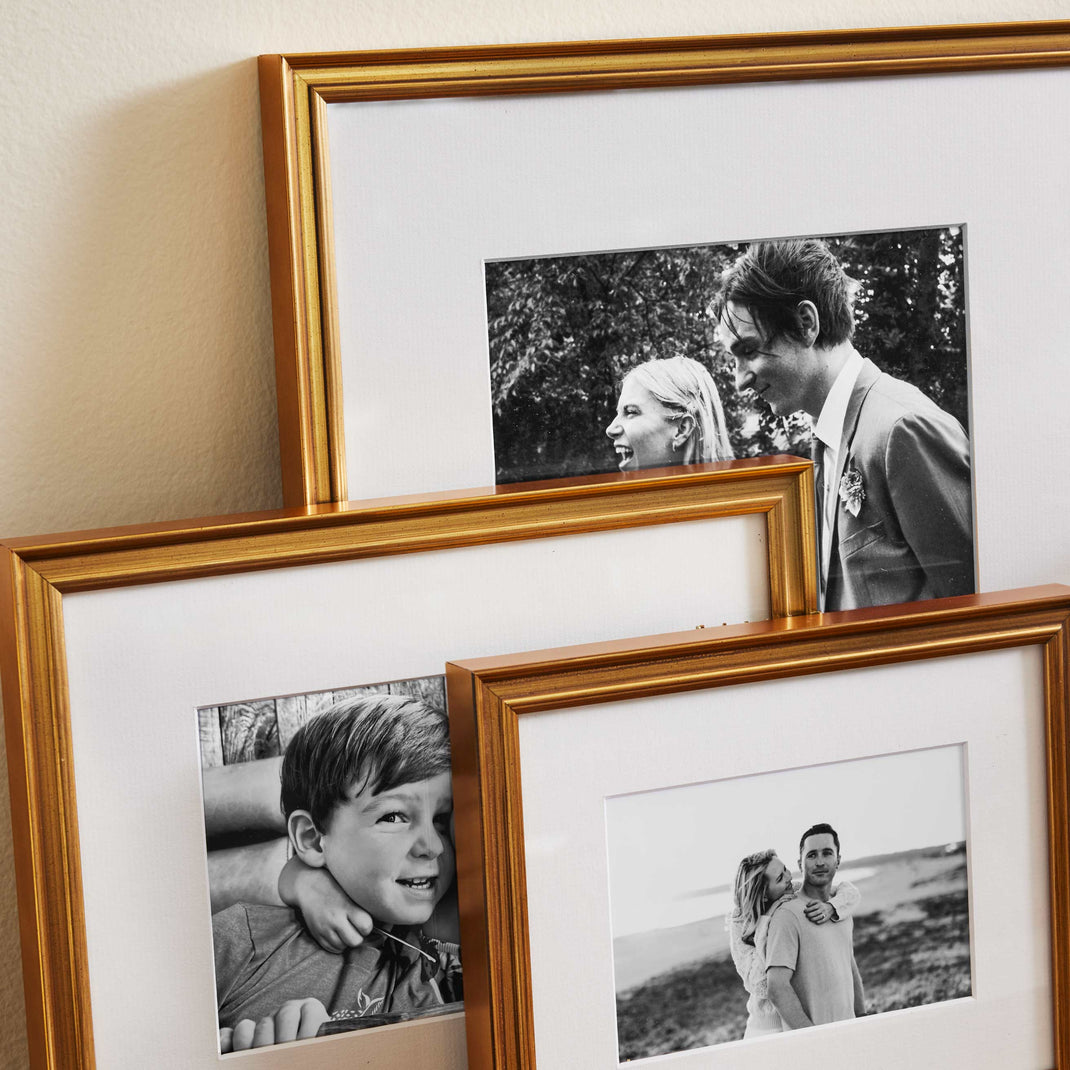 Timeless Trio Gallery Wall gold frames leaning against a wall