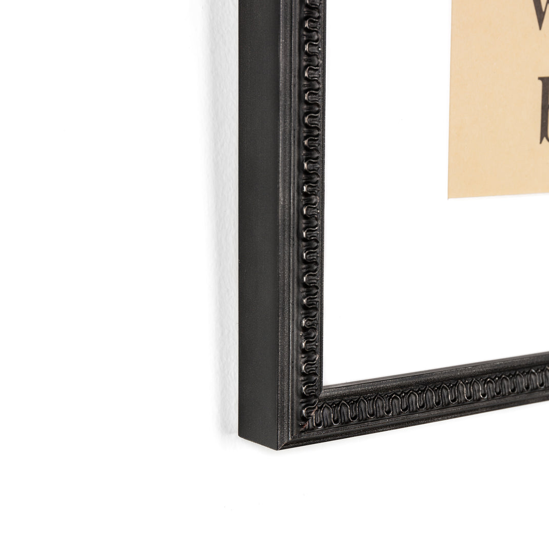 bottom left corner of pages of a sight words book framed in wavy matte black Gresham frame with white mat