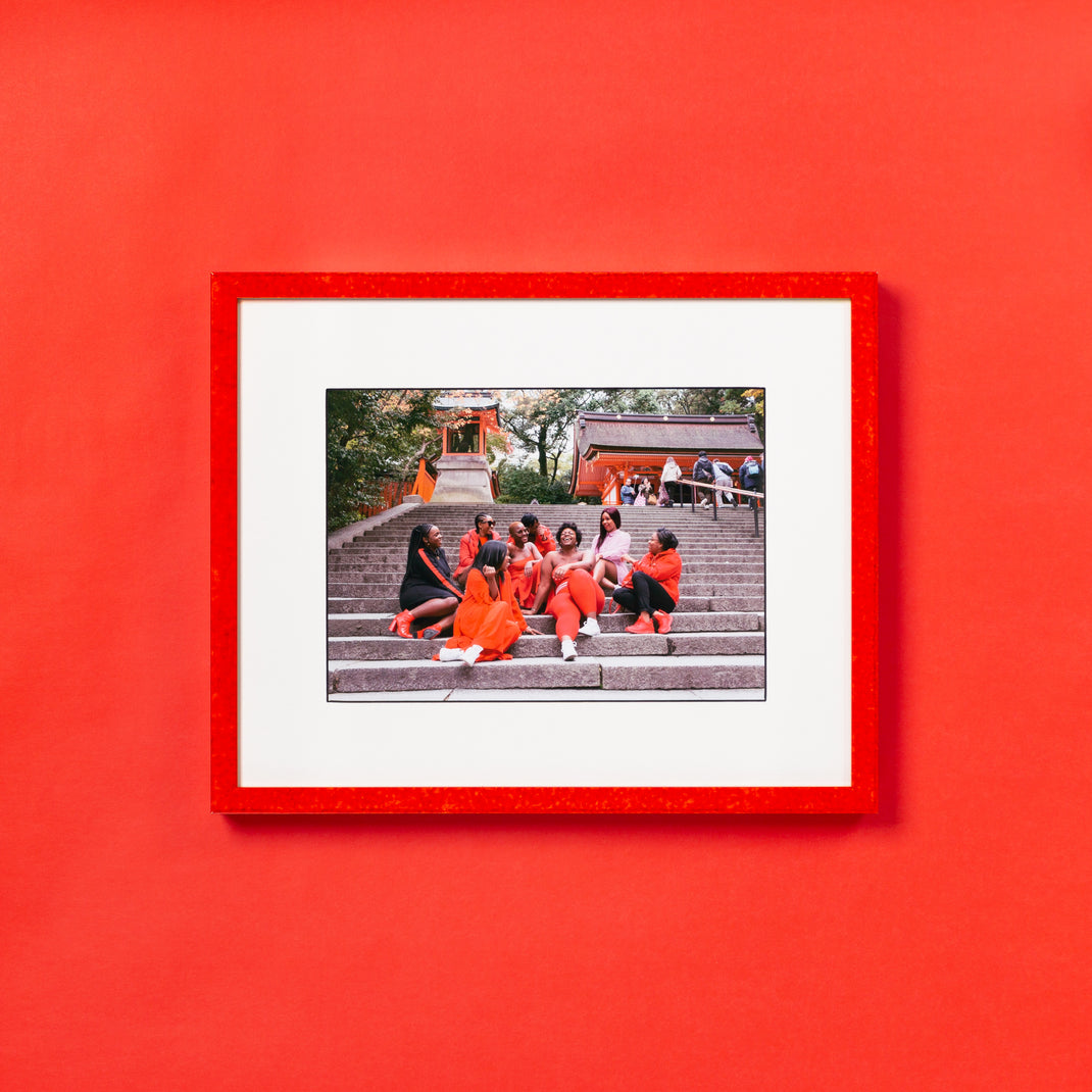 photograph of girls sitting on steps in Kyoto red glazed frame