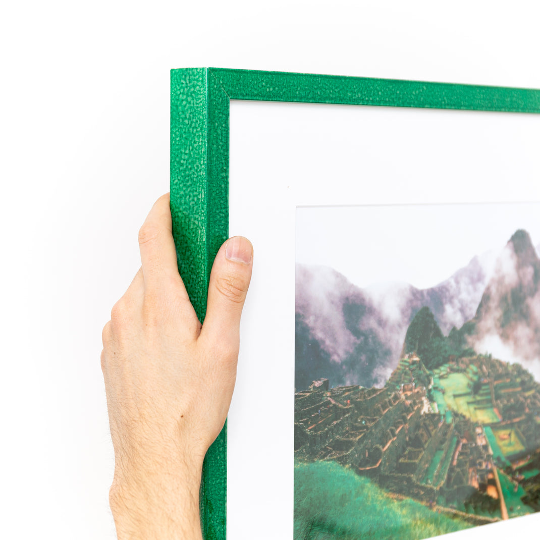 top left corner of photograph of Machu Picchu framed in glazed emerald green Lima frame with a white mat