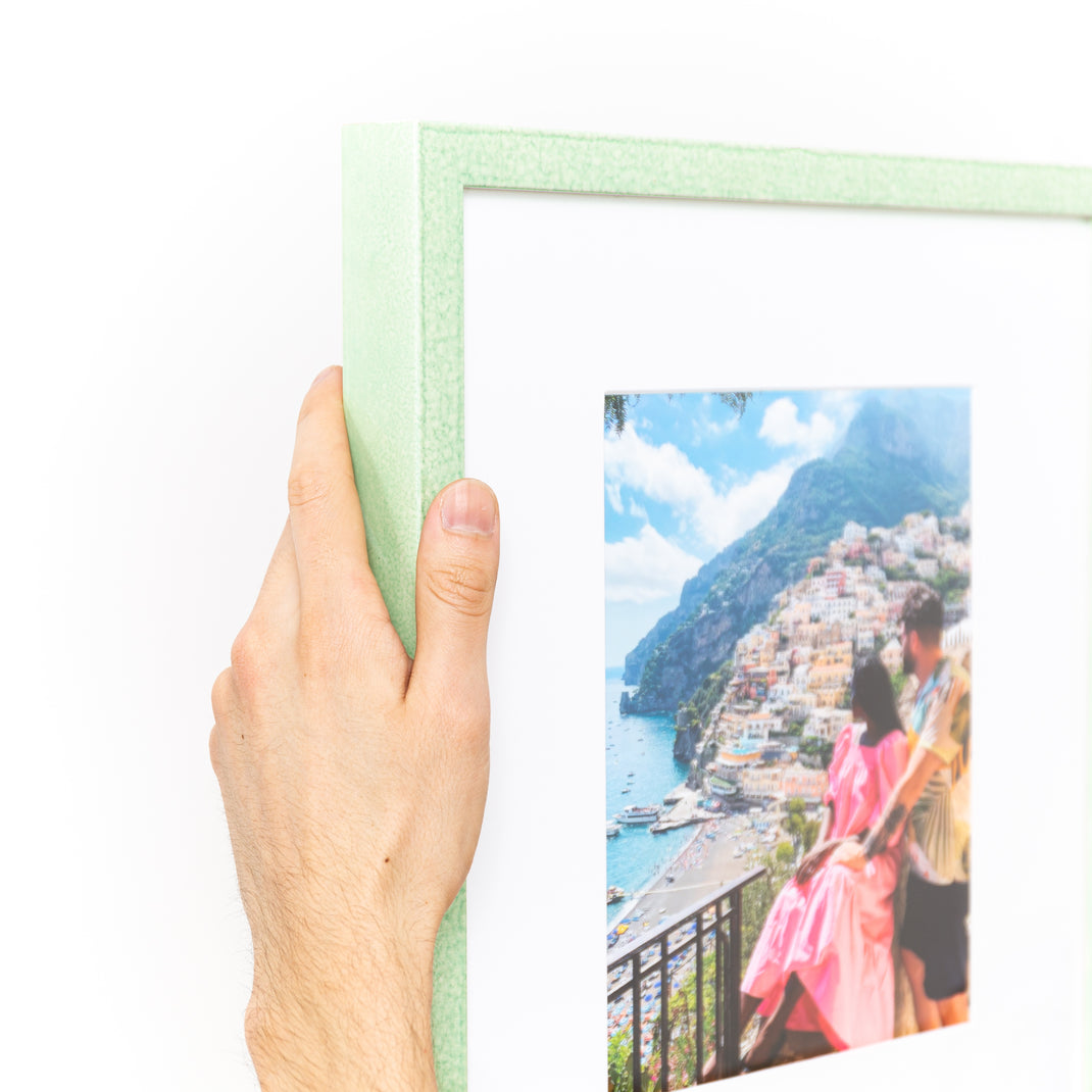 top left corner of photo of a couple in Italy framed in mint green glazed Positano frame