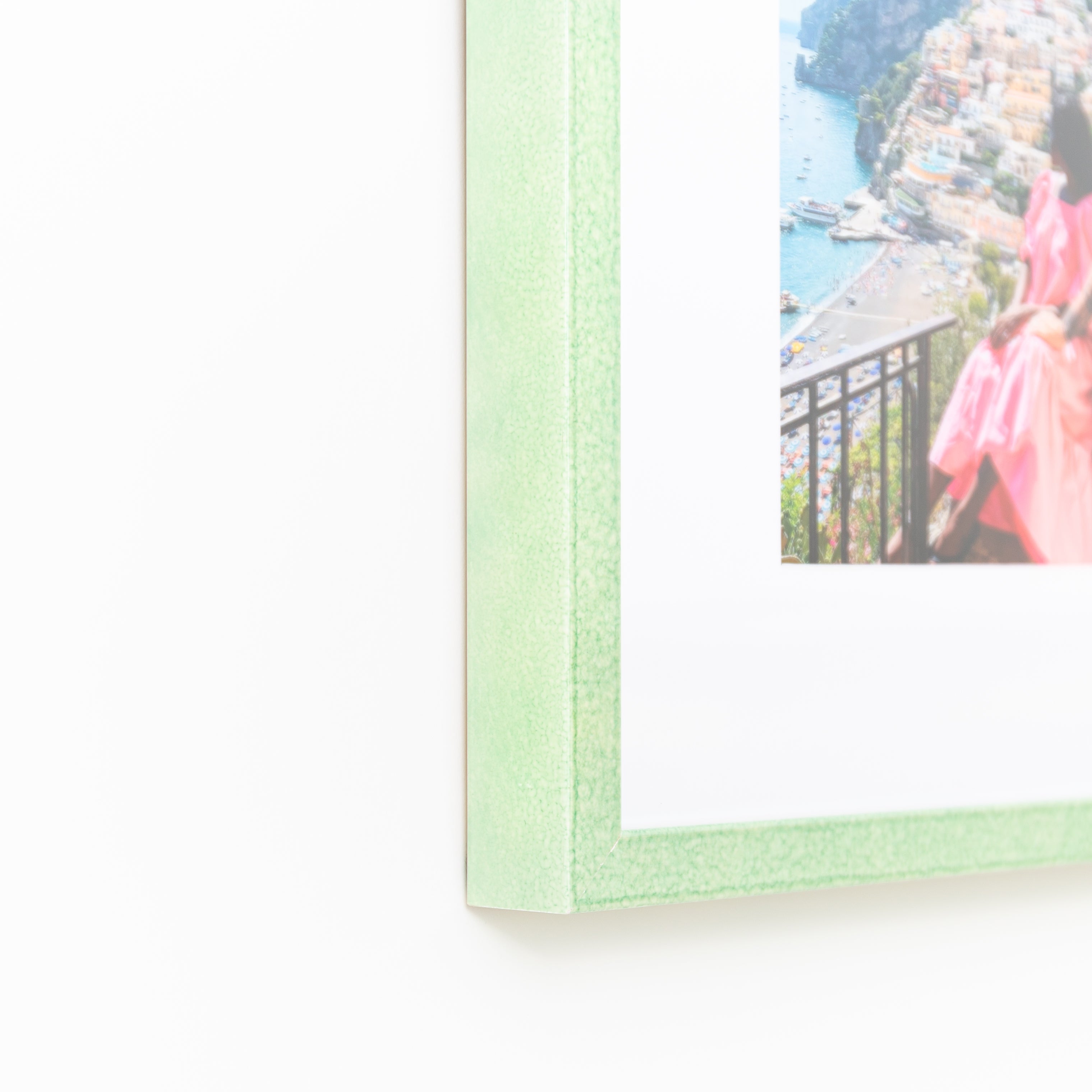 bottom left corner of photo of a couple in Italy framed in mint green glazed Positano frame