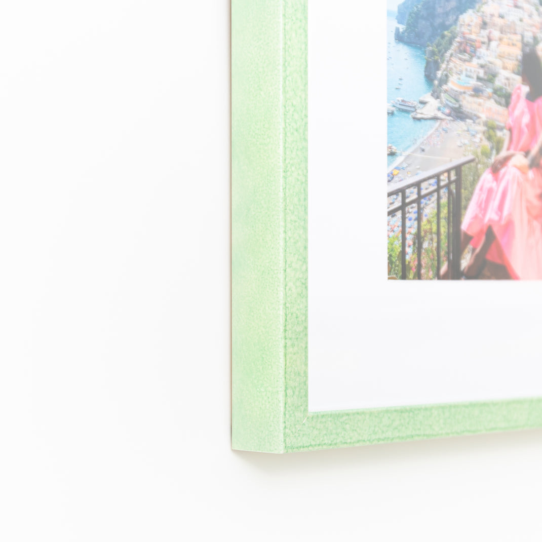 bottom left corner of photo of a couple in Italy framed in mint green glazed Positano frame