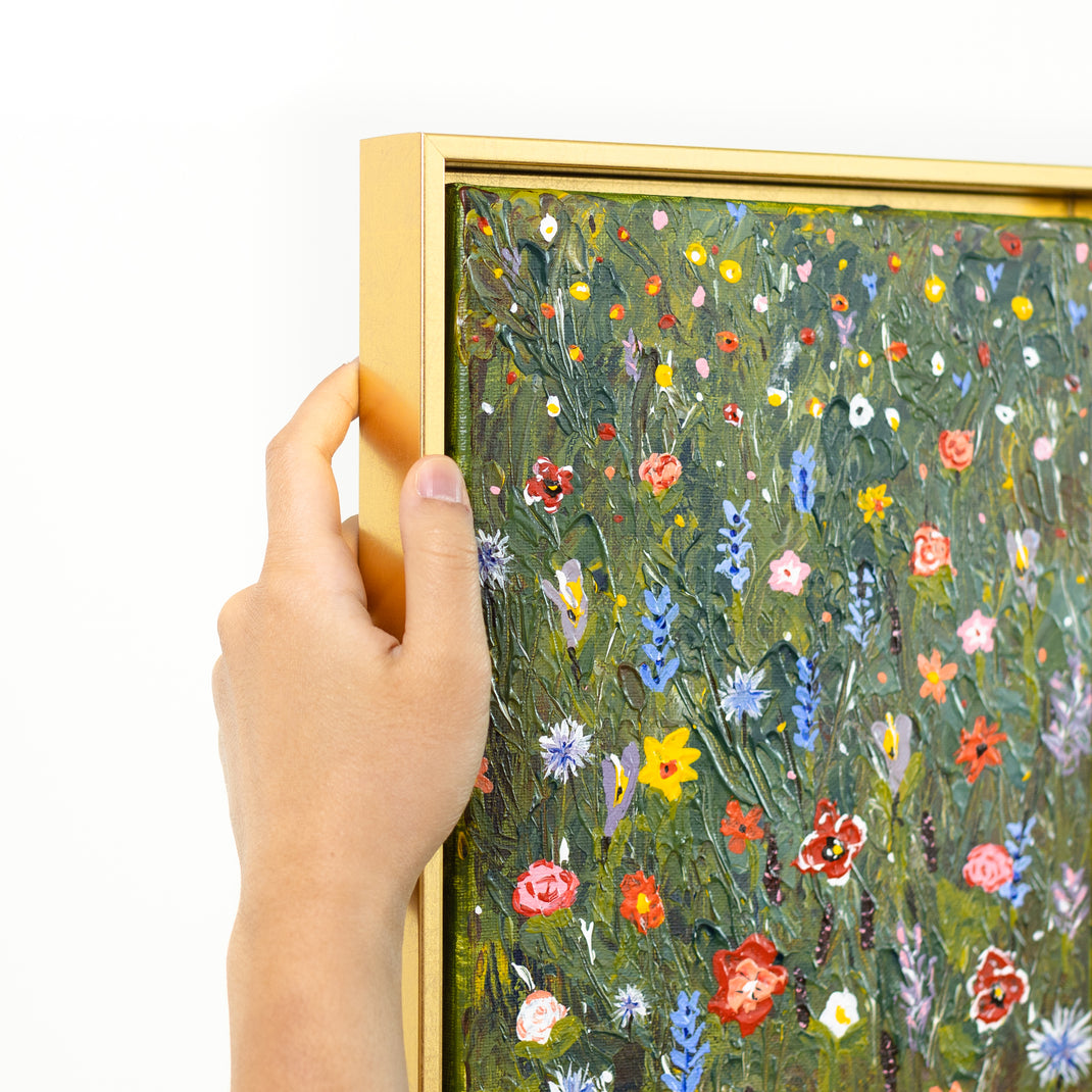top left corner of painting of wildflowers on canvas framed in Quito gold canvas floater frame