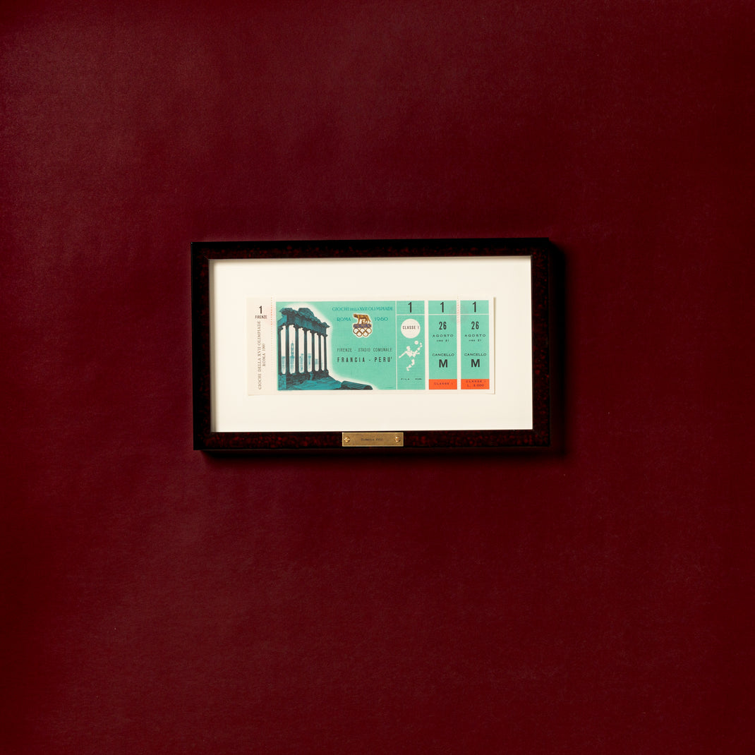 ticket framed in deep burgundy glazed Rome frame with a white mat