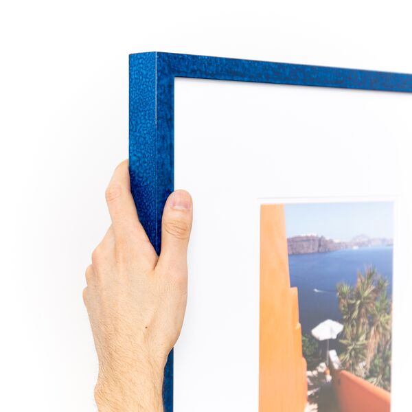 top left corner of a landscape photo framed in royal blue glazed Santorini frame with a white mat
