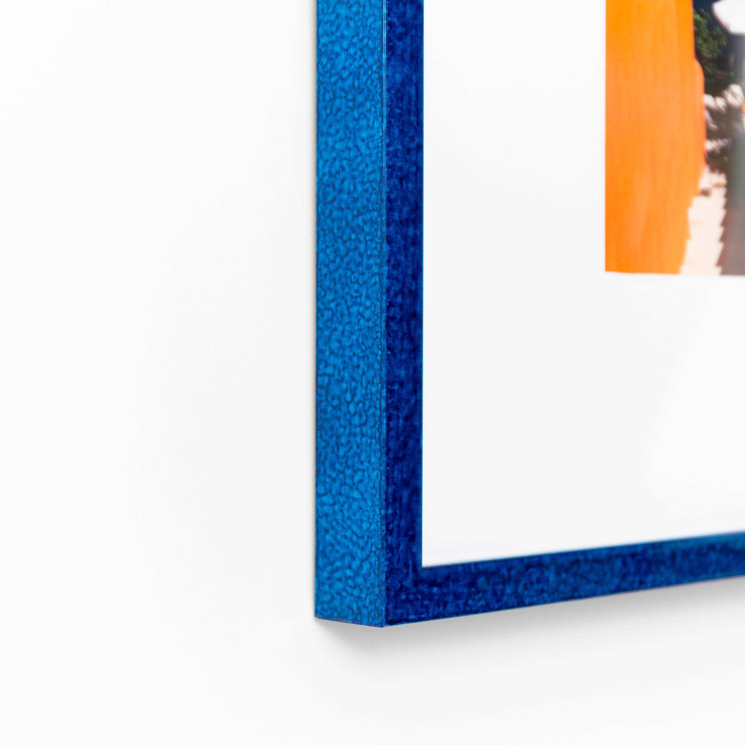 bottom left corner of a landscape photo framed in royal blue glazed Santorini frame with a white mat