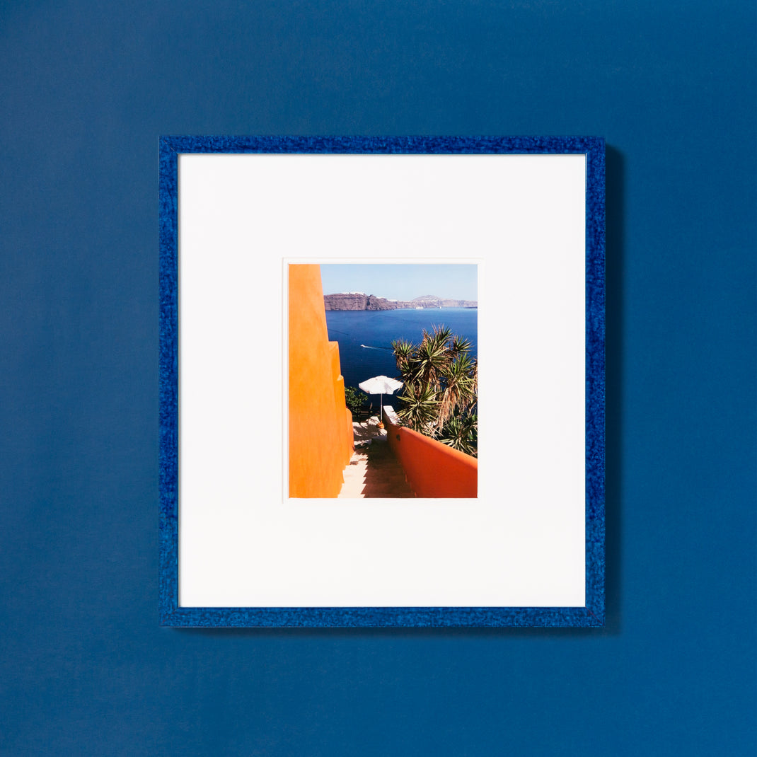 landscape photo framed in framed in royal blue glazed Santorini frame with a white mat