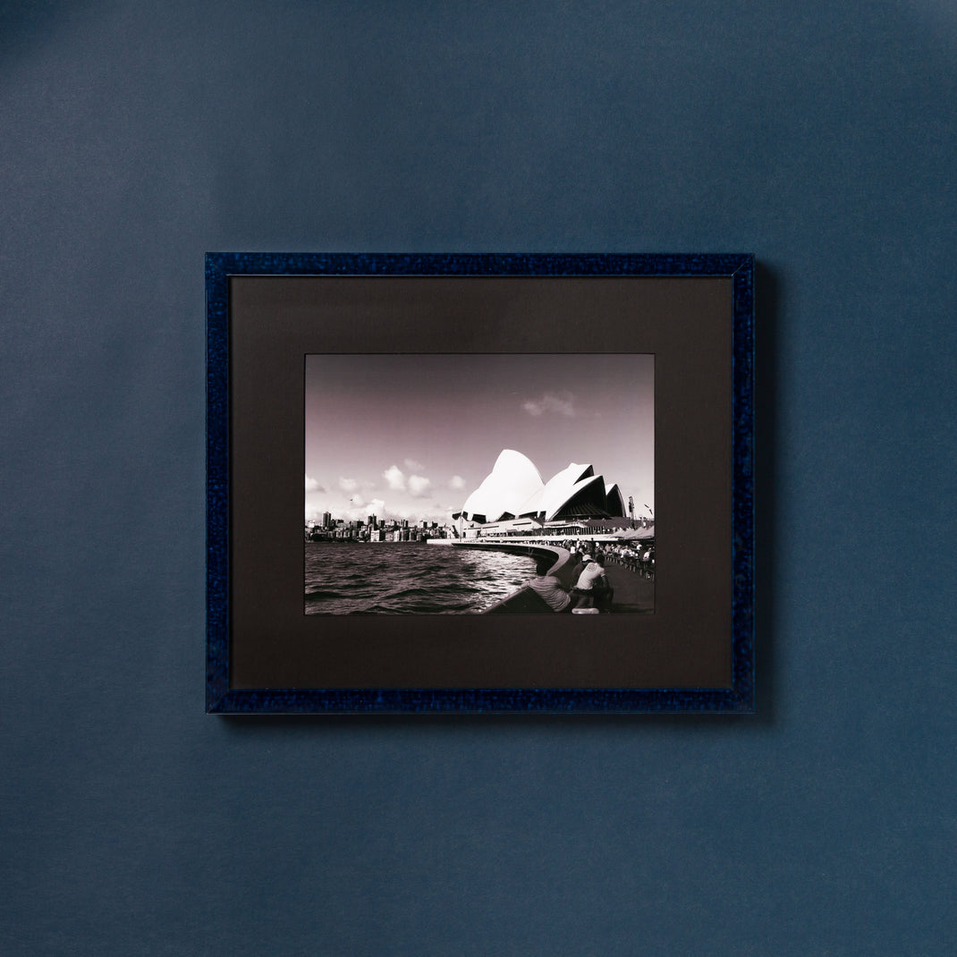 black and white photo of the Sydney opera house framed in deep blue glazed Sydney frame with a black mat