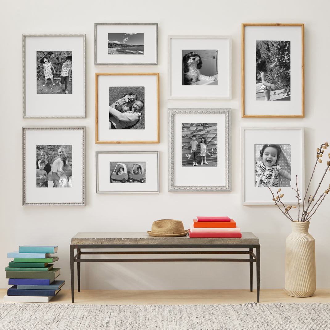 Silver and natural frames on a wall