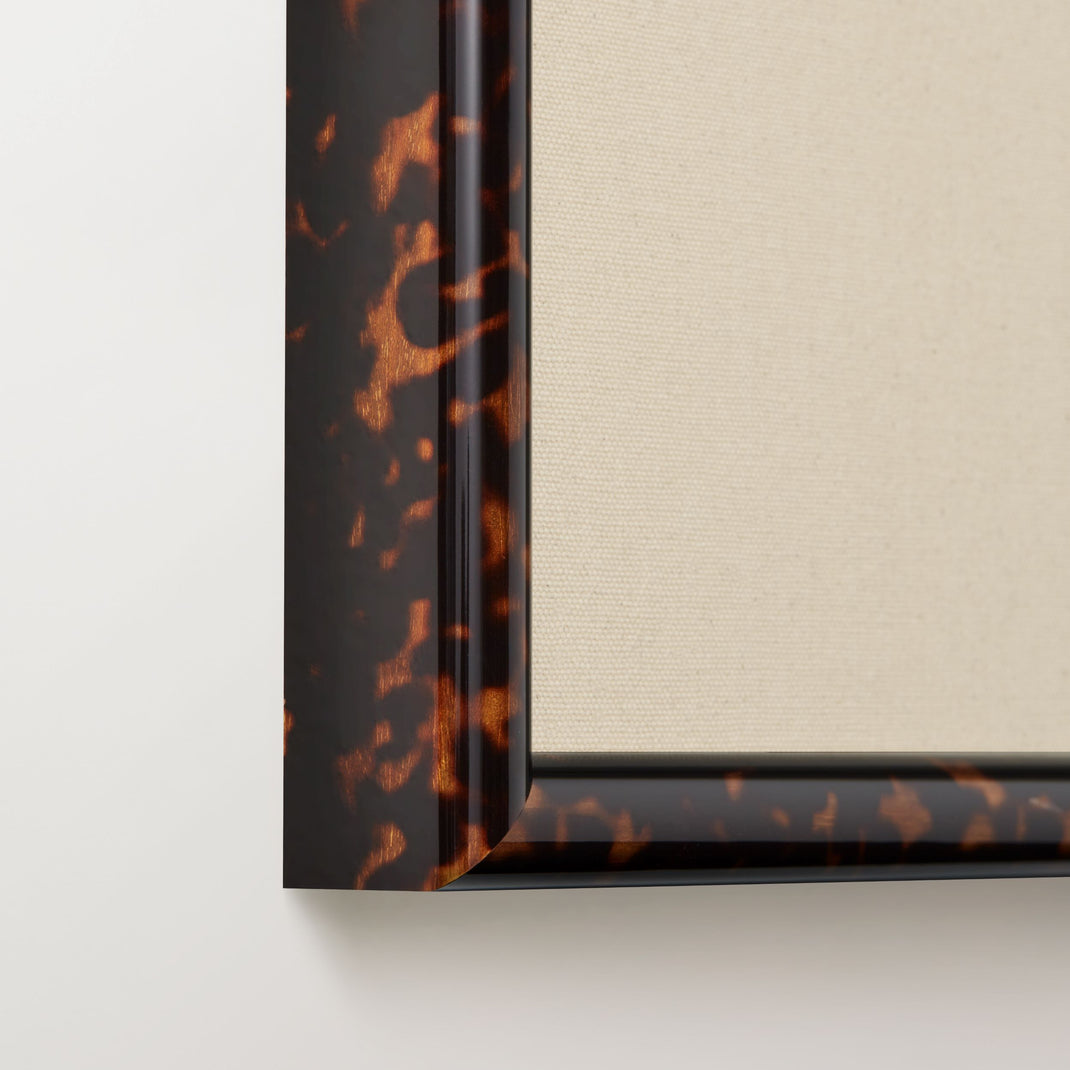 bottom left corner of a beach photo framed in tortoise Toulouse frame