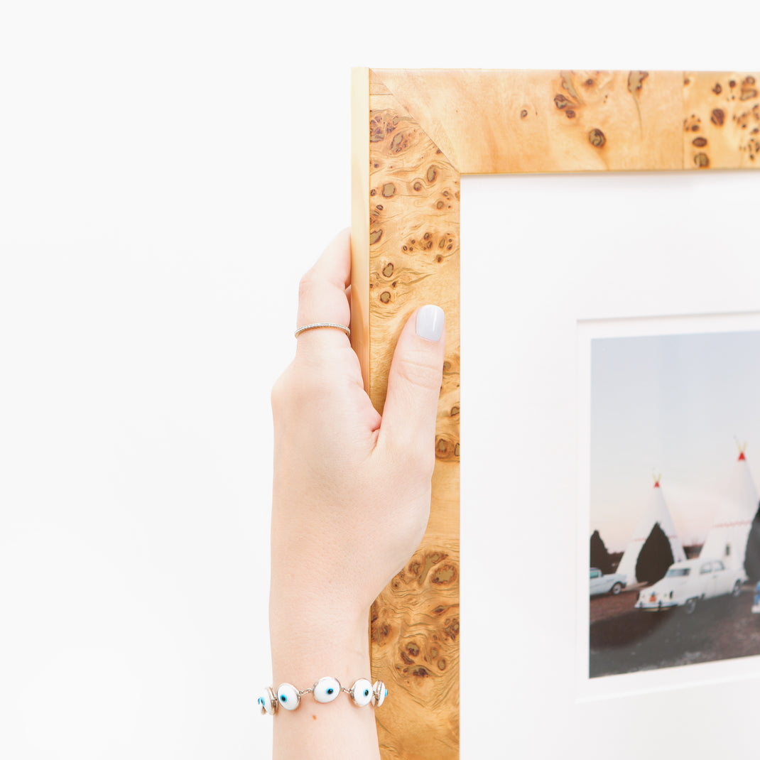 top left corner of photograph of tents at a campsite framed in Cairo burl wood frame with a white mat