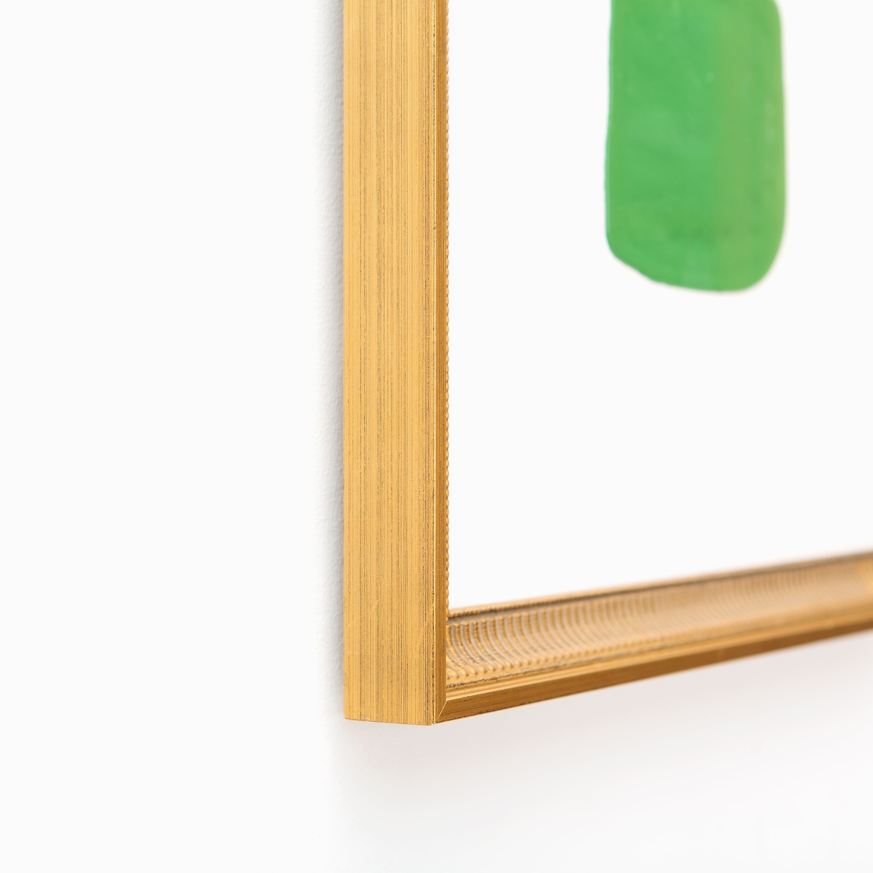 bottom left corner of abstract blue and green art framed in antique fluted gold Georgetown frame with a white mat