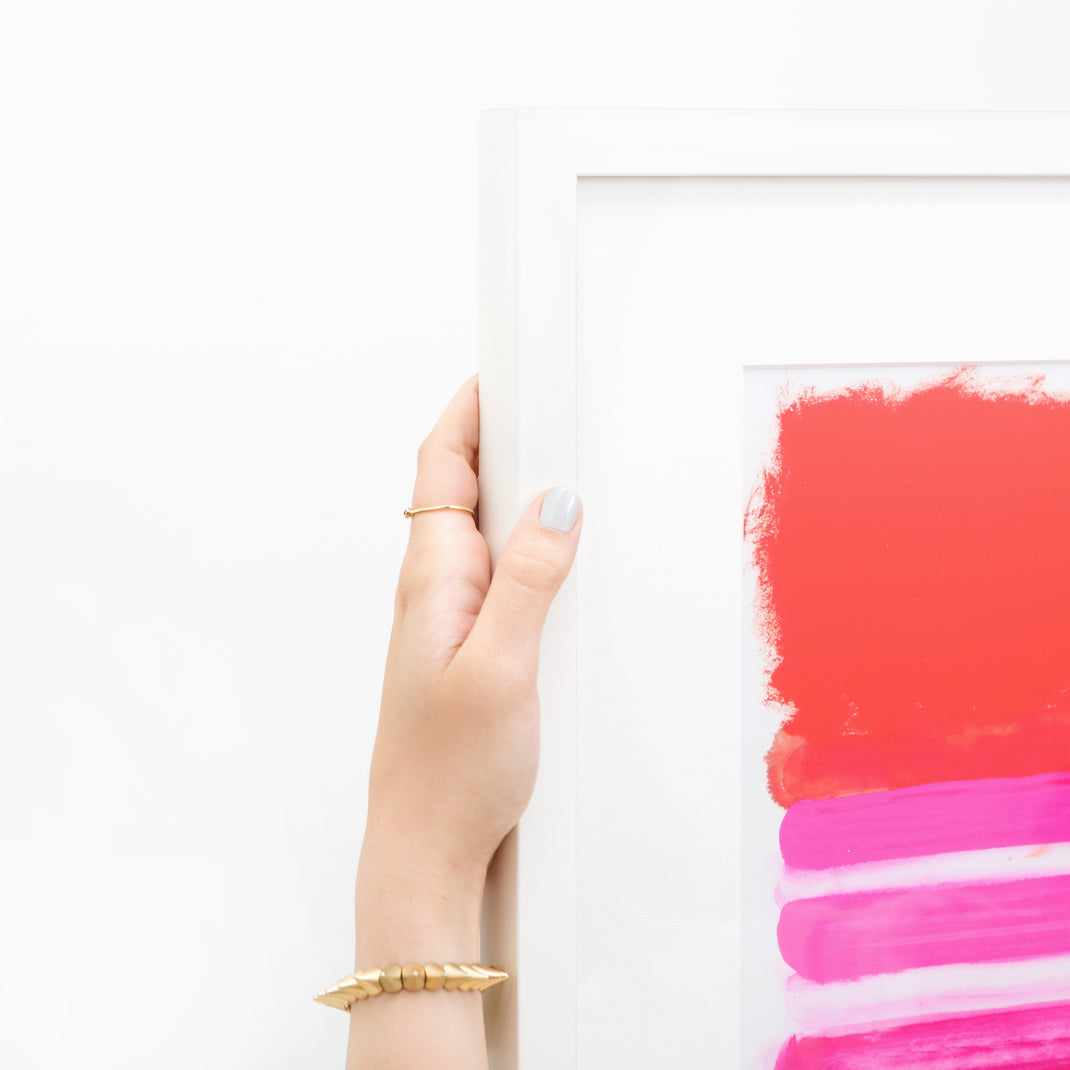 top left corner of pink and red abstract art print framed in Irvine Slim thin white gallery frame with a white mat