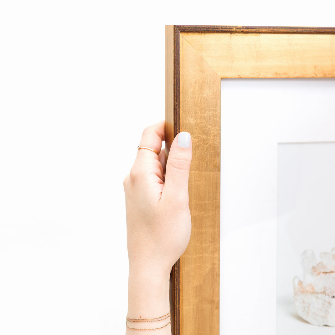 top left corner of pink geode framed in wide gold Potomac frame with a white mat