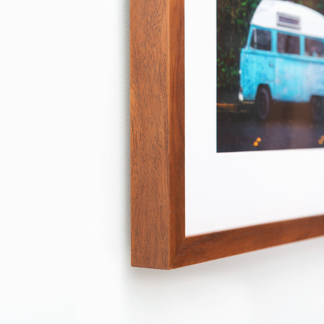 bottom left corner of photo of a vintage vw bus framed in warm natural wood Sonoma frame